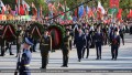 Символ исторической памяти: сотни белорусов посетили монумент Победы в Минске с цветами и портретами фронтовиков